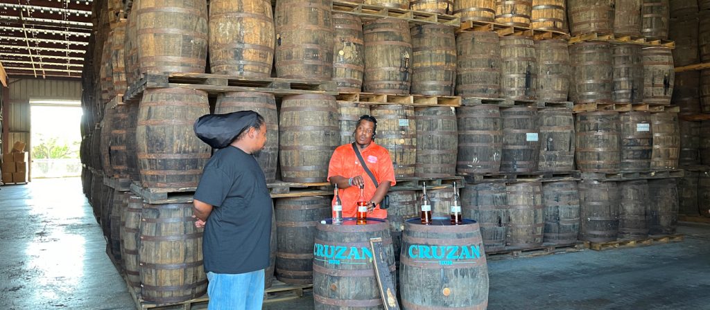 edit_cruzan-rum_barrel-room tour guide in front of barrels of aging rum